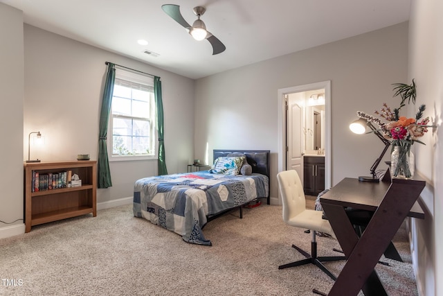 carpeted bedroom featuring ensuite bath and ceiling fan