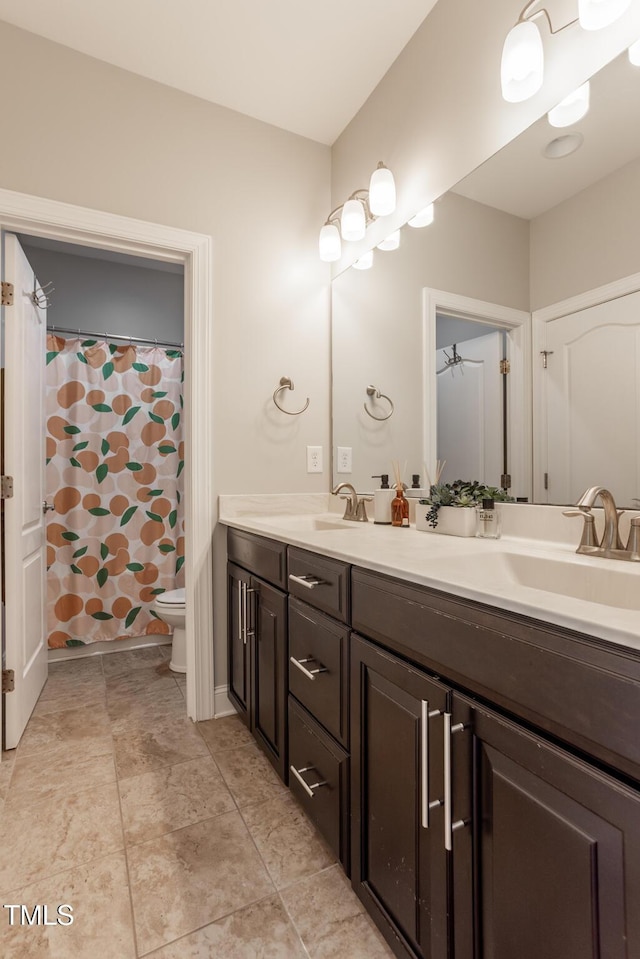 bathroom featuring ceiling fan, vanity, a shower with shower curtain, and toilet