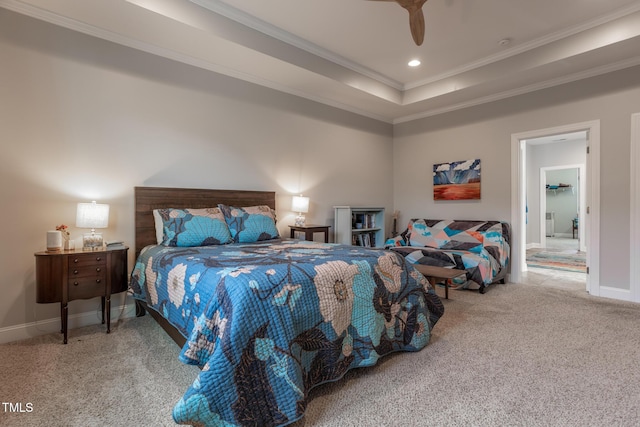 carpeted bedroom with a tray ceiling, ceiling fan, and crown molding