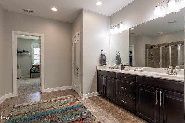 bathroom with vanity, tile patterned floors, and a shower with shower door