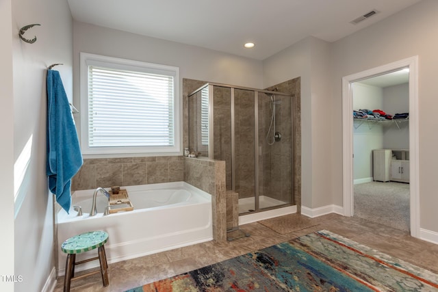 bathroom featuring separate shower and tub and tile patterned flooring