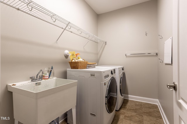 clothes washing area featuring washing machine and clothes dryer and sink