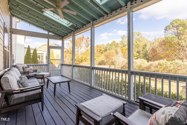 sunroom with ceiling fan and lofted ceiling