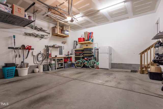 garage featuring electric panel and white fridge