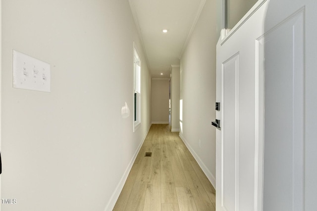 hall with crown molding and light hardwood / wood-style floors