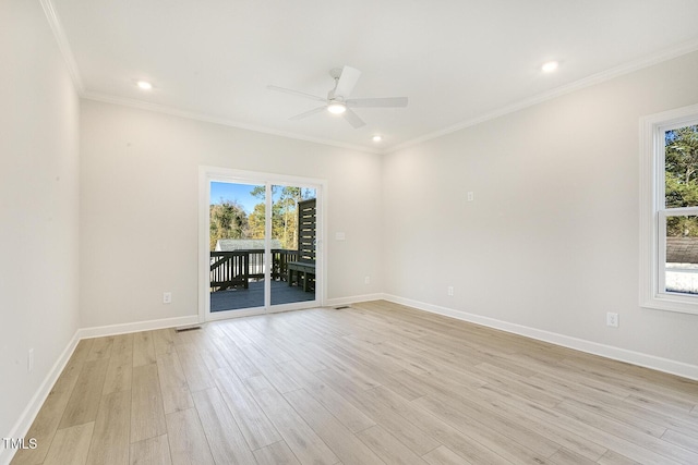 unfurnished room featuring a wealth of natural light, ceiling fan, ornamental molding, and light wood-type flooring