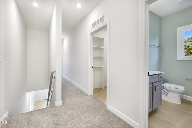 corridor with light hardwood / wood-style flooring