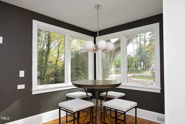 dining area featuring hardwood / wood-style flooring and a healthy amount of sunlight