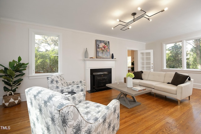 living room featuring a wealth of natural light, hardwood / wood-style floors, and ornamental molding