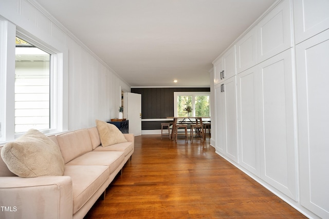 living room with crown molding and hardwood / wood-style floors