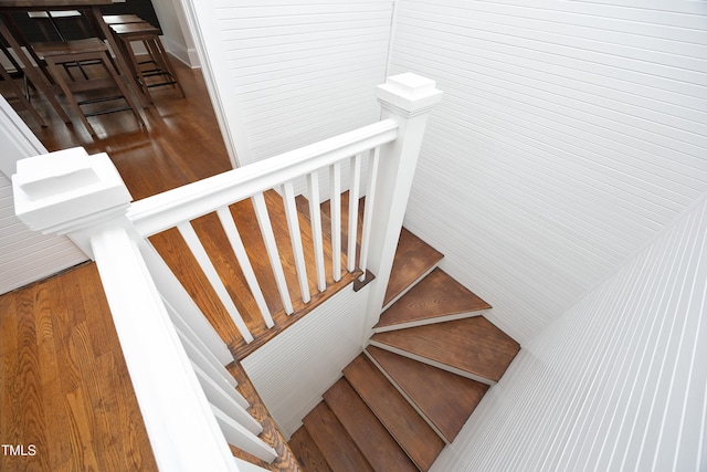 stairs featuring hardwood / wood-style floors