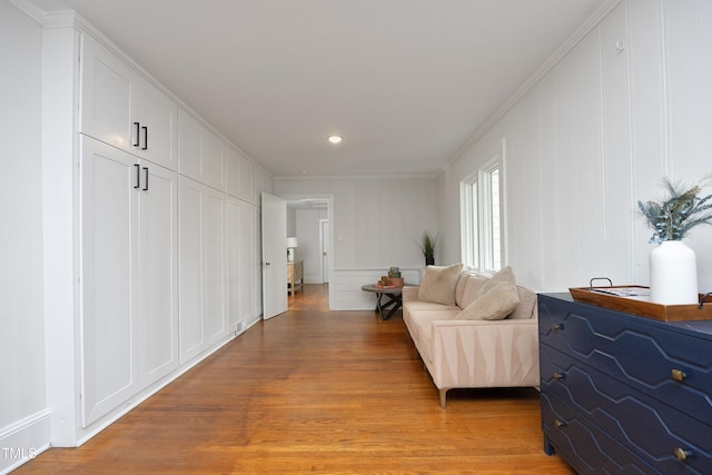 interior space featuring light hardwood / wood-style floors and crown molding