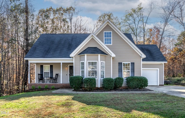 view of front facade featuring covered porch, a garage, and a front lawn