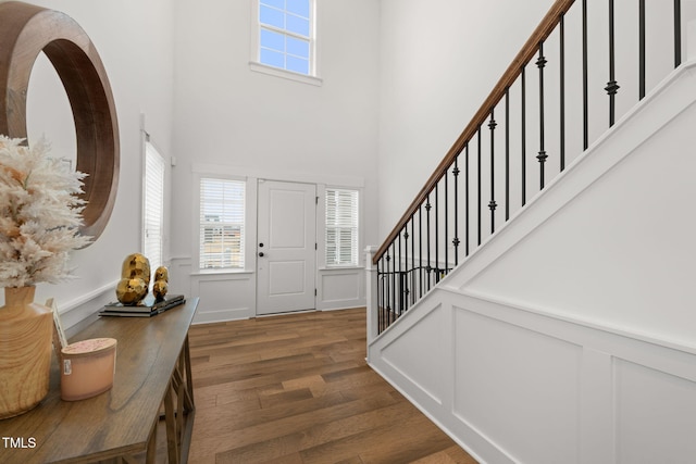 entrance foyer featuring dark wood-type flooring and a high ceiling