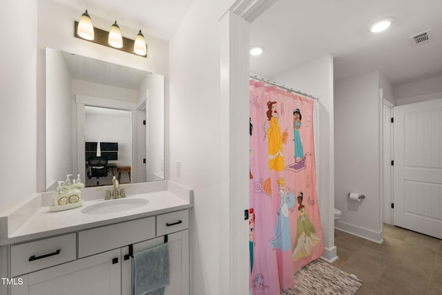 bathroom with toilet, vanity, and a shower with shower curtain