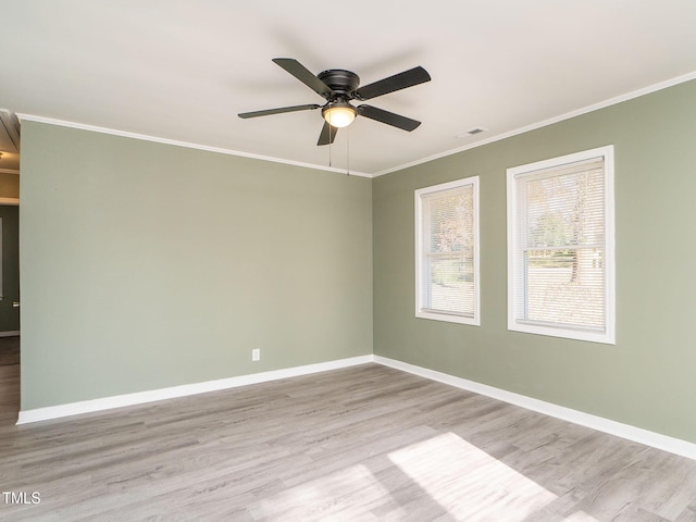 spare room featuring light hardwood / wood-style flooring, ceiling fan, and crown molding