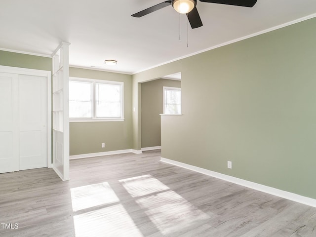 spare room with light hardwood / wood-style floors, ceiling fan, and ornamental molding