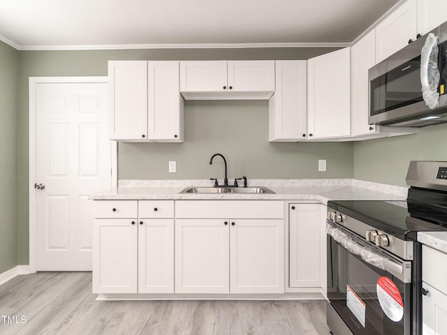 kitchen featuring white cabinets, stainless steel appliances, and sink