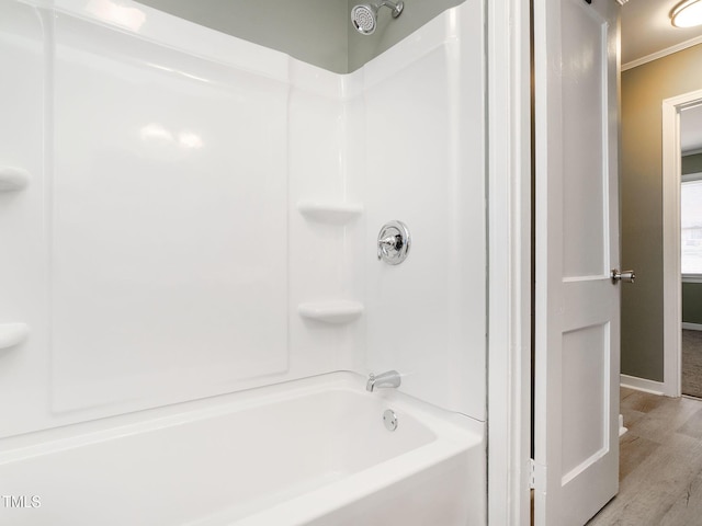 bathroom featuring wood-type flooring and shower / tub combination