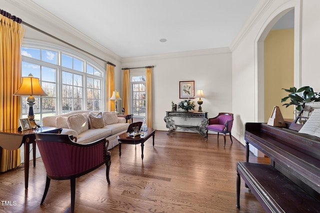 living room with wood-type flooring and crown molding