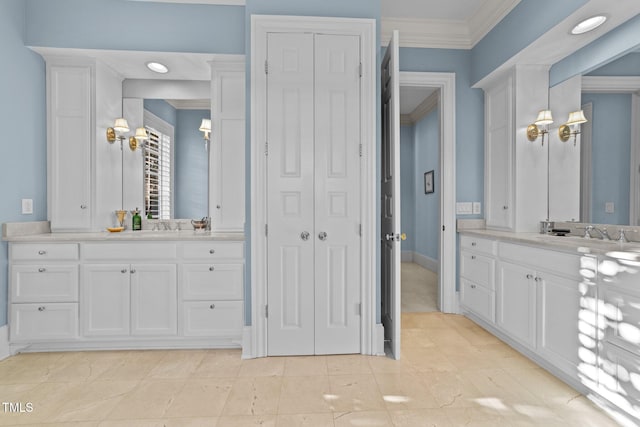 bathroom featuring crown molding and vanity