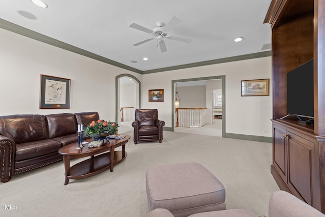 carpeted living room featuring ceiling fan and crown molding