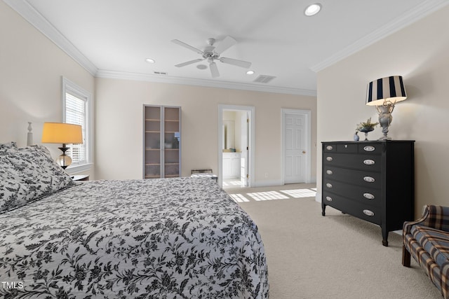 carpeted bedroom with ensuite bathroom, ceiling fan, and ornamental molding