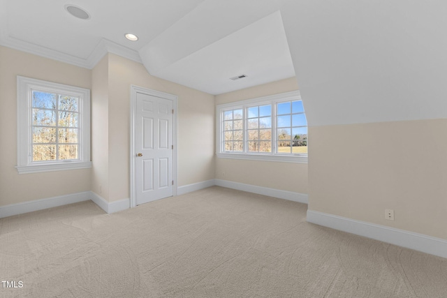 interior space with ornamental molding, light carpet, and lofted ceiling