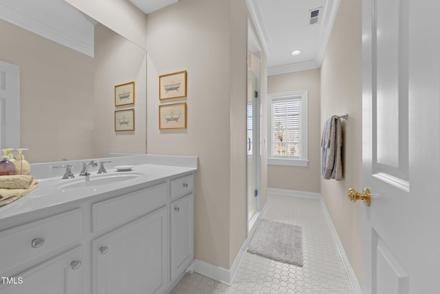 bathroom with tile patterned floors, crown molding, and vanity