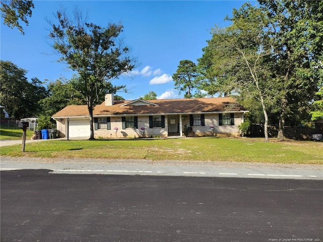 ranch-style house with a front lawn and a garage