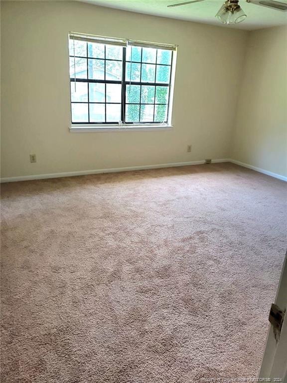 empty room featuring carpet flooring and ceiling fan