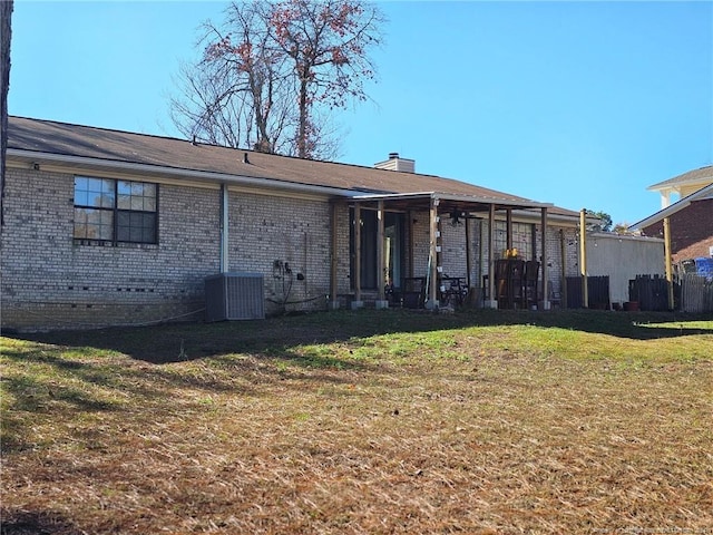 back of house with a yard and cooling unit