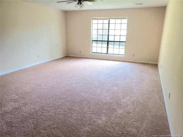 carpeted empty room featuring ceiling fan