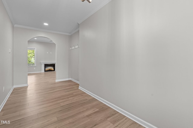 hall with light hardwood / wood-style flooring and ornamental molding