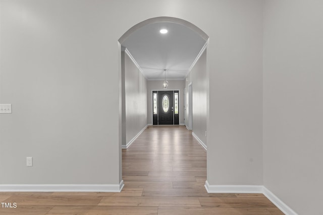 entryway featuring light hardwood / wood-style floors and ornamental molding