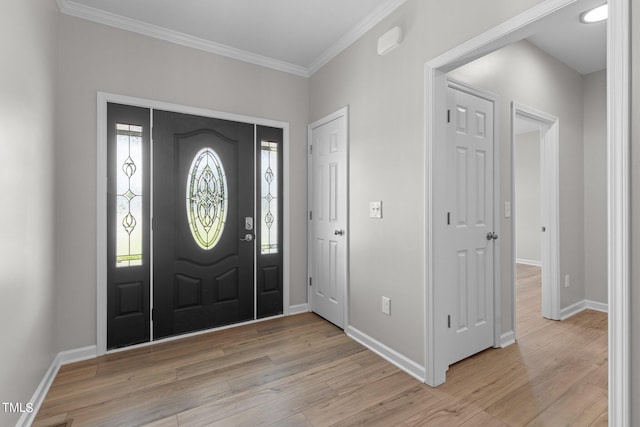 entryway with crown molding and light hardwood / wood-style floors