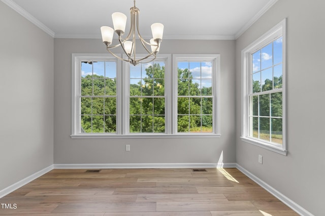 unfurnished dining area featuring a chandelier, light hardwood / wood-style floors, and a healthy amount of sunlight