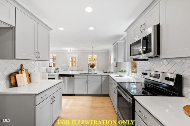 kitchen featuring sink, appliances with stainless steel finishes, tasteful backsplash, light hardwood / wood-style floors, and decorative light fixtures