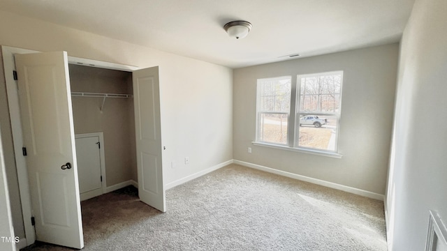 unfurnished bedroom with carpet floors and a closet