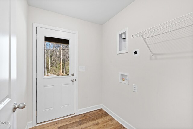 laundry area featuring hookup for a washing machine, hookup for an electric dryer, light wood-type flooring, laundry area, and baseboards