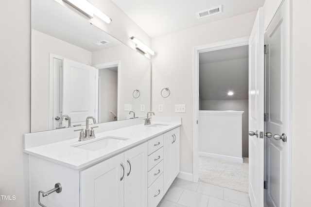 full bath featuring double vanity, visible vents, and a sink