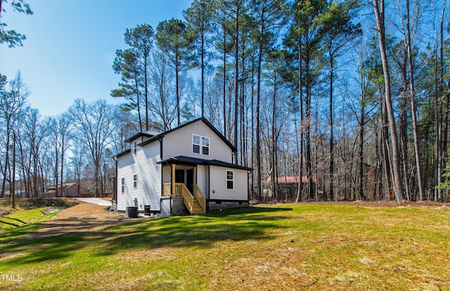 view of front of house featuring a front lawn and central AC unit