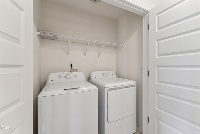 clothes washing area with laundry area and independent washer and dryer