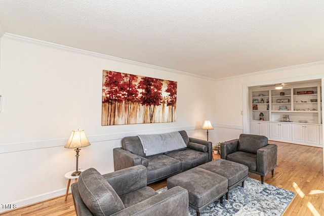 living room with hardwood / wood-style flooring, crown molding, and a textured ceiling