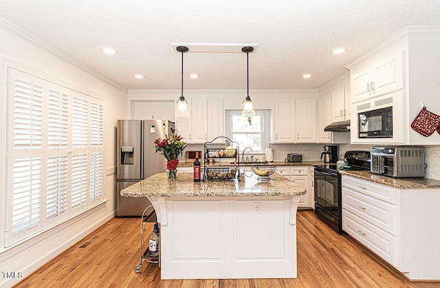 kitchen with an island with sink, white cabinetry, light hardwood / wood-style floors, and black appliances