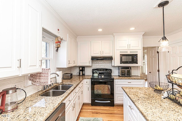 kitchen with decorative backsplash, sink, black appliances, white cabinets, and hanging light fixtures