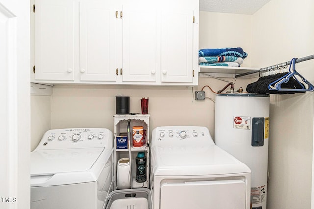 laundry room with washer and dryer, a textured ceiling, cabinets, and water heater