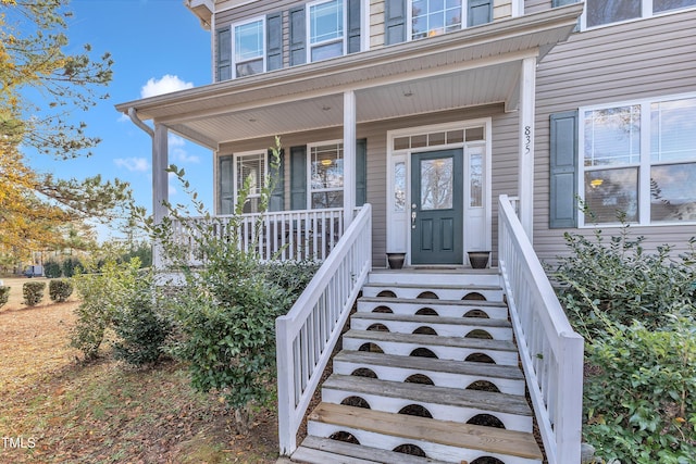 view of exterior entry with a porch