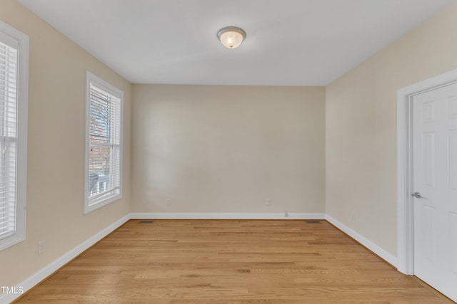 unfurnished room with light hardwood / wood-style floors