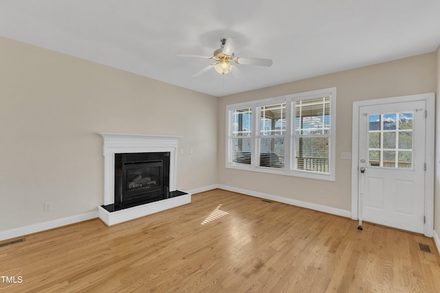 unfurnished living room featuring ceiling fan and light hardwood / wood-style floors